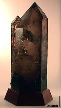 Smoky Quartz; St. Gothard - Canton Uri - Switzerland,  This great specimen was collected in the year 1868 and came from the famous, now legendary, Tiefengletscher grotto, a large pocket that produced about 22,000 pounds of smoky quartz. The largest surviving crystal (in the Natural History Museum of Berne) weighs more than 300 pounds. An excellent article on this occurrence, written by Dr. Wendell E. Wilson, appeared in Mineralogical Record, July- August, 1984. The excellent crystal offered for sale here seems to be more perfect at the termination (a fragile place, indeed) than those depicted in the article and its rich brown smoky quartz color is not typical of the 'smoky dark brown to black color' described. It is reasonable to conclude that this is one of the best known since it once was in the private collection of Clarence S. Bement, indeed, it is the only such specimen that I have ever heard of in the mineral specimen market. It is a very large, quite transparent, slightly compound crystal with its base sawn. The habit is identical to the specimen depicted in the article. A little artistic restoration was done at the base to even the prism out, but that is entirely reversible. It sits on a custom-made pearwood base. An important and historic specimen. 9-5/8x3-7/8x3-1/4 inches.  $9500.  